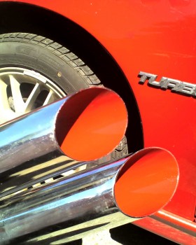 The camera keeps washing-out the red to an orange color, but the high-temp paint inside the tips are almost the same red as the car.