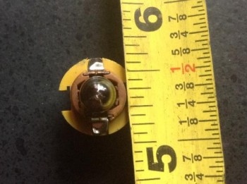 About 3/8 inch hole -just under the 194 bulb's diameter.