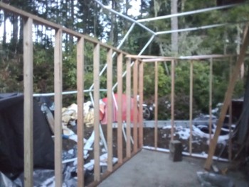 Framing work. The construction-area looks like a bomb went off around it, but I just didn't have any better place to stash some of these parts.  And the old Kawasaki...<br />The white tubing was used to 'tent' the concrete slab during and after the pour.  Controlling the heat was critical when constructing this time of year.